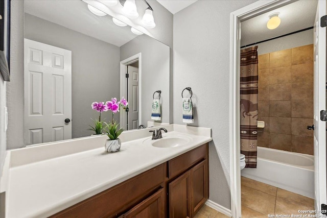 full bathroom featuring tile patterned flooring, vanity, toilet, shower / tub combo with curtain, and a textured wall
