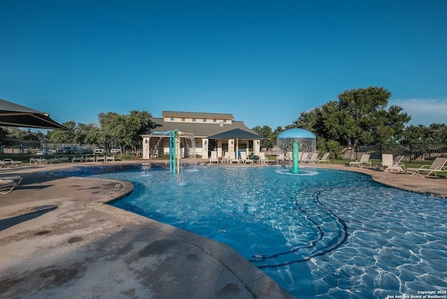 pool featuring fence and a patio area