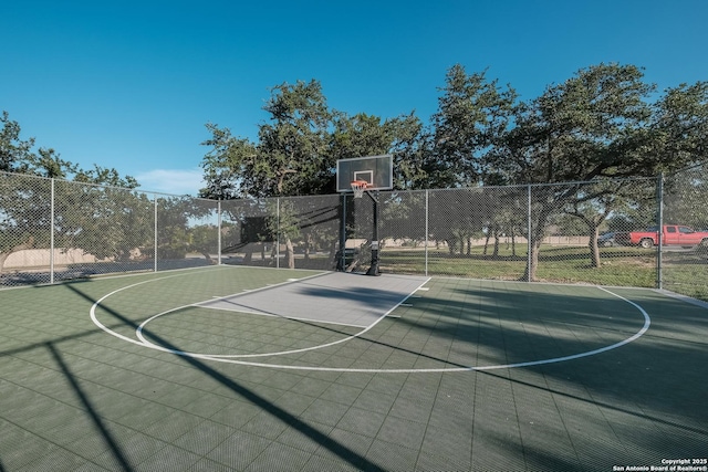 view of basketball court with community basketball court and fence