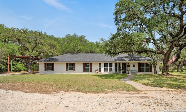 23 Sunrise, Pleasanton, TX 78064 - single story home with a carport, brick siding, and a front yard