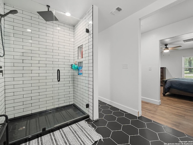 23 Sunrise, Pleasanton, TX 78064 - ensuite bathroom featuring visible vents, tile patterned flooring, baseboards, ceiling fan, and a shower stall