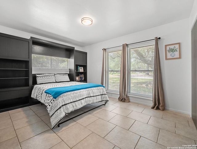 23 Sunrise, Pleasanton, TX 78064 - bedroom with baseboards and light tile patterned floors