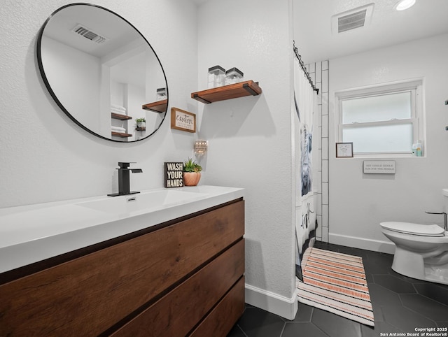 23 Sunrise, Pleasanton, TX 78064 - bathroom with toilet, visible vents, tile patterned flooring, and vanity