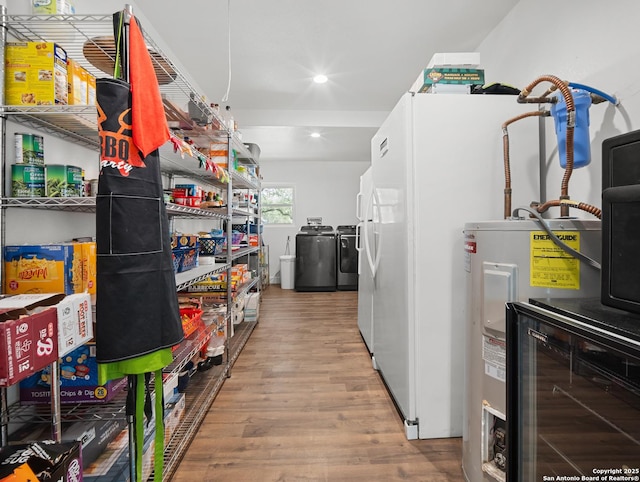 23 Sunrise, Pleasanton, TX 78064 - interior space with wood finished floors, recessed lighting, washing machine and dryer, and electric water heater