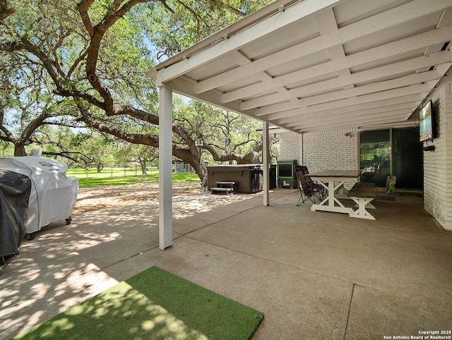 23 Sunrise, Pleasanton, TX 78064 - view of patio / terrace with outdoor dining area and a hot tub