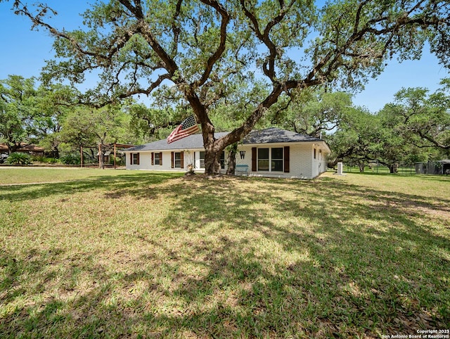 23 Sunrise, Pleasanton, TX 78064 - rear view of house with a lawn and fence