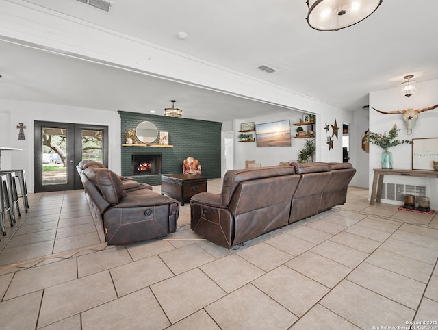 23 Sunrise, Pleasanton, TX 78064 - living area with visible vents, light tile patterned floors, and a fireplace