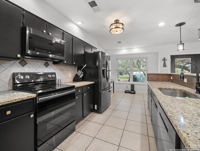 23 Sunrise, Pleasanton, TX 78064 - kitchen featuring dark cabinets, appliances with stainless steel finishes, and a sink
