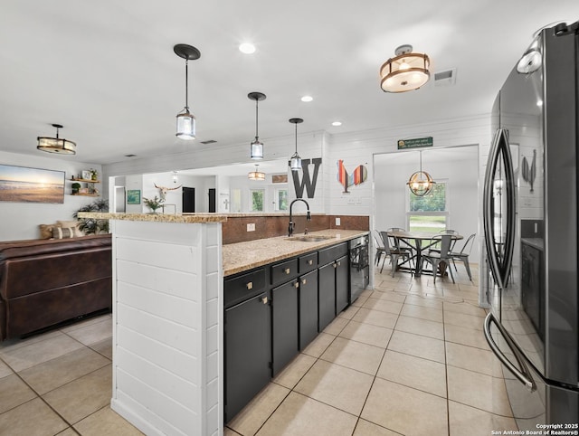 23 Sunrise, Pleasanton, TX 78064 - kitchen featuring visible vents, a sink, light tile patterned floors, freestanding refrigerator, and dishwashing machine