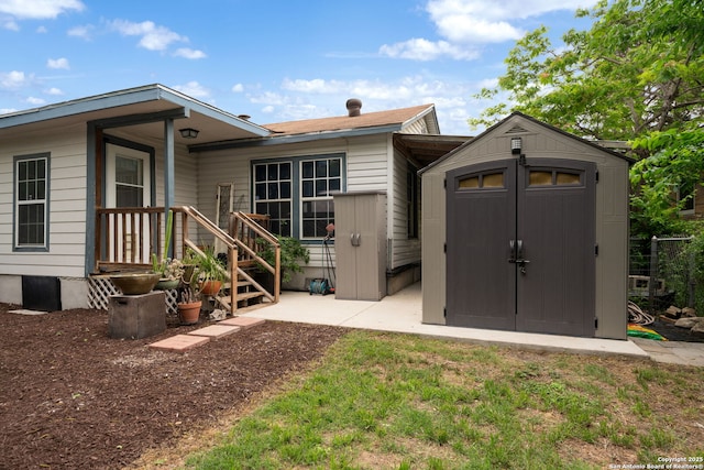 back of property featuring an outbuilding and a storage unit