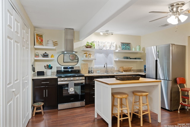kitchen featuring visible vents, open shelves, ceiling fan, island range hood, and appliances with stainless steel finishes