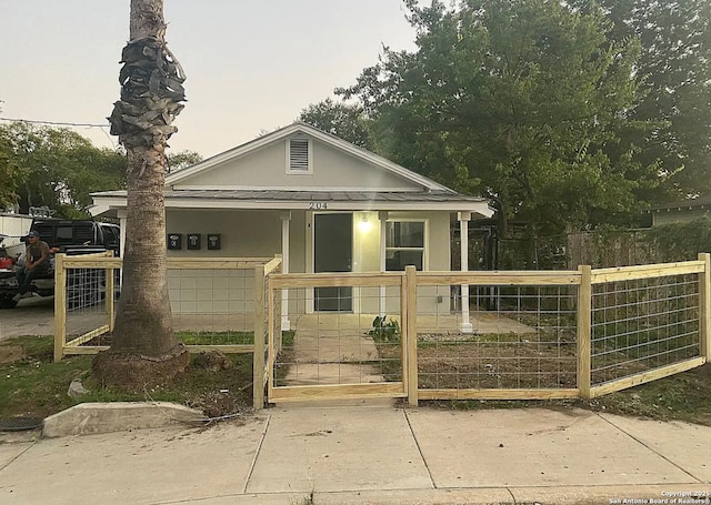 204 Division, San Antonio, TX 78214 - view of front of property featuring a garage, a fenced front yard, a gate, and stucco siding