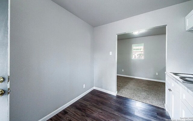 204 Division, San Antonio, TX 78214 - unfurnished room with dark wood-style flooring and baseboards