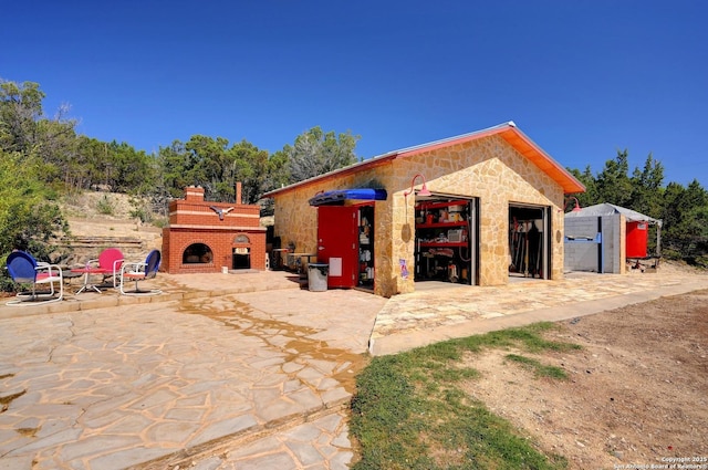 324 E Headwaters Rnch, Kendalia, TX 78027 - exterior space featuring an outdoor brick fireplace