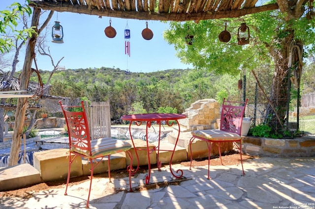 324 E Headwaters Rnch, Kendalia, TX 78027 - view of patio / terrace featuring a forest view and fence