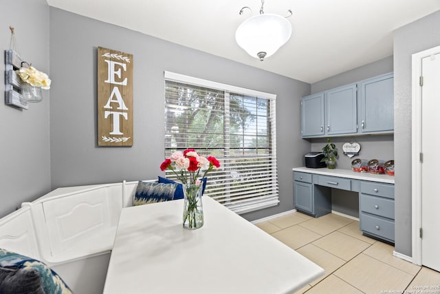 5211 Wood Gln, San Antonio, TX 78244 - interior space featuring hanging light fixtures, built in study area, light countertops, gray cabinets, and light tile patterned floors