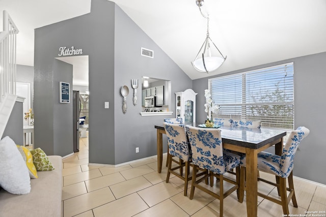 5211 Wood Gln, San Antonio, TX 78244 - dining area featuring visible vents, baseboards, light tile patterned floors, and high vaulted ceiling