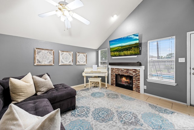 5211 Wood Gln, San Antonio, TX 78244 - living room with tile patterned floors, a tiled fireplace, a ceiling fan, baseboards, and vaulted ceiling