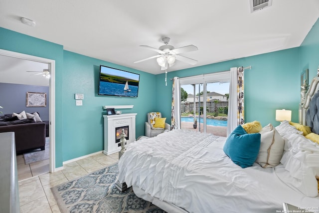 5211 Wood Gln, San Antonio, TX 78244 - bedroom with ceiling fan, a lit fireplace, visible vents, access to exterior, and baseboards
