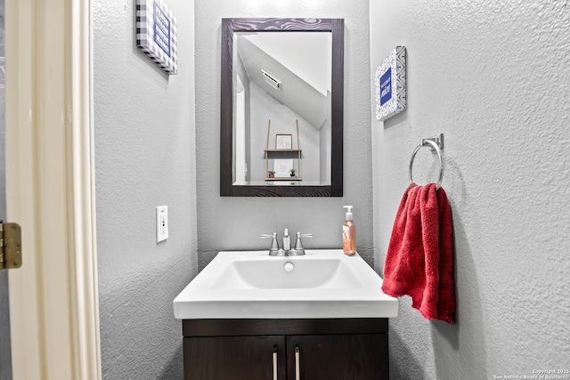 5211 Wood Gln, San Antonio, TX 78244 - bathroom featuring a textured wall and vanity