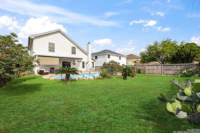 5211 Wood Gln, San Antonio, TX 78244 - rear view of property with a fenced backyard, a fenced in pool, and a lawn