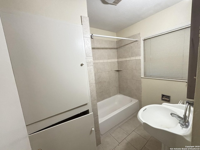 bathroom with  shower combination, a sink, and tile patterned floors