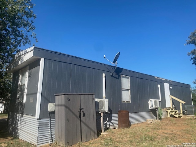 view of side of home featuring entry steps and central AC