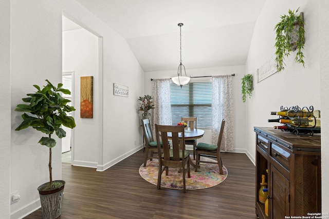 dining space featuring baseboards, vaulted ceiling, and dark wood finished floors
