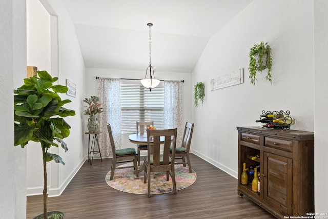dining area featuring baseboards, dark wood finished floors, and lofted ceiling