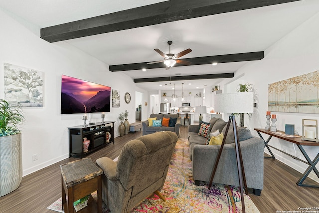 living area with baseboards, a ceiling fan, beam ceiling, and wood finished floors