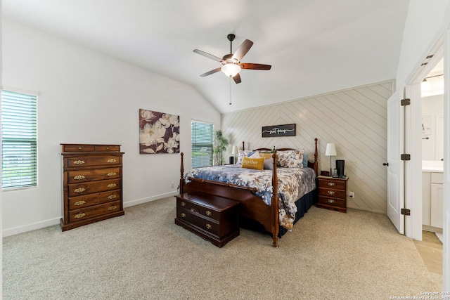 carpeted bedroom with baseboards, wood walls, ceiling fan, and vaulted ceiling