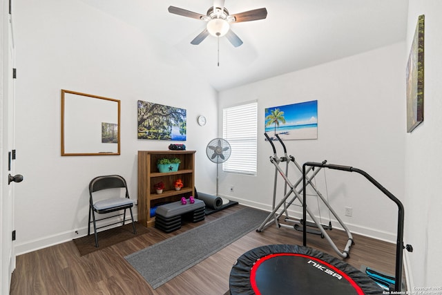 exercise room with baseboards, lofted ceiling, wood finished floors, and ceiling fan