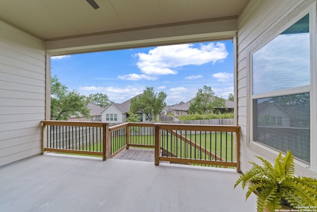 view of patio featuring a residential view, fence, and ceiling fan