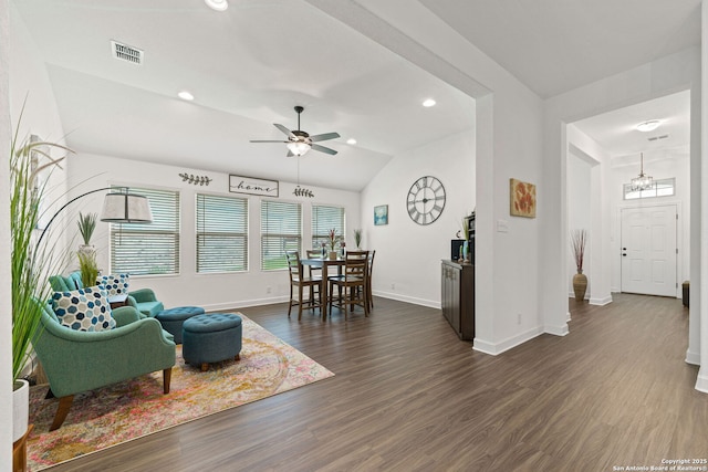 living area with visible vents, a ceiling fan, dark wood finished floors, and baseboards