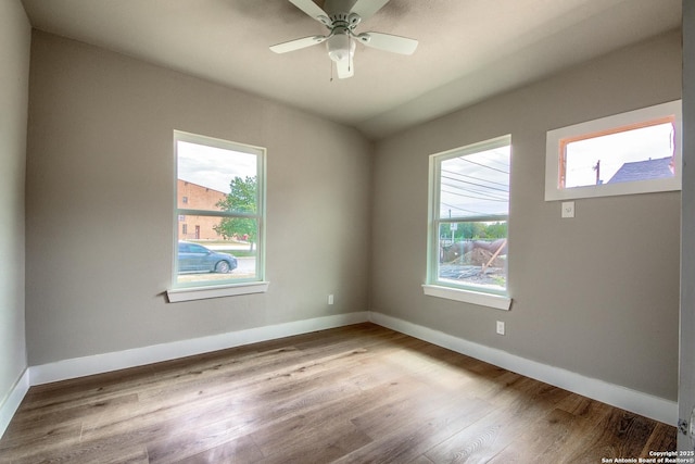 spare room with a ceiling fan, baseboards, and wood finished floors