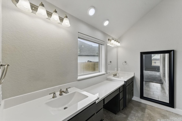 full bathroom with double vanity, a sink, vaulted ceiling, and a wealth of natural light