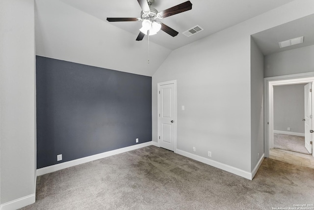 unfurnished bedroom with visible vents, carpet flooring, and lofted ceiling