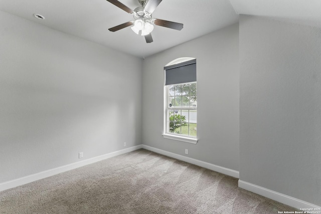carpeted empty room with baseboards and ceiling fan