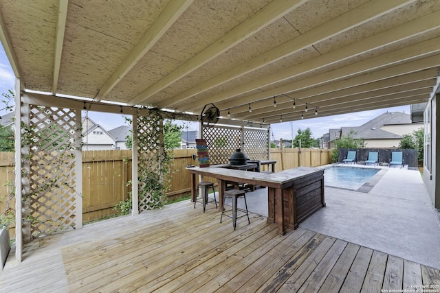 deck with a fenced backyard and a patio