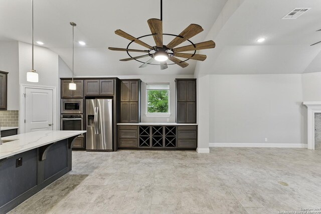 kitchen with visible vents, a ceiling fan, appliances with stainless steel finishes, and vaulted ceiling