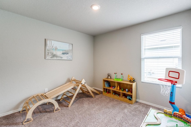 rec room with baseboards and carpet flooring