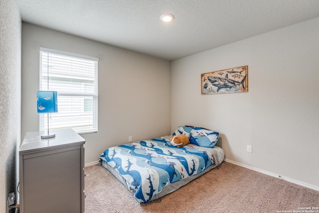 bedroom featuring baseboards and light carpet
