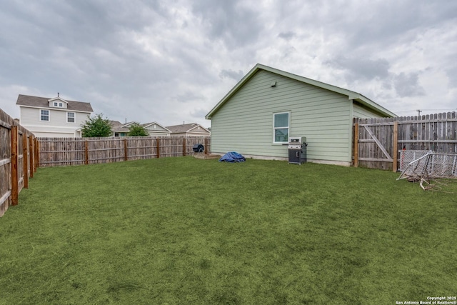 exterior space with a fenced backyard and a yard