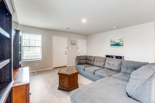 living room with visible vents, recessed lighting, light wood finished floors, and baseboards