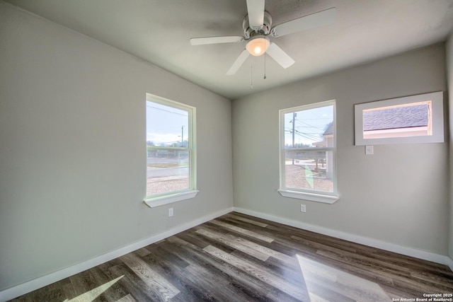 empty room with a ceiling fan, baseboards, and dark wood-style floors
