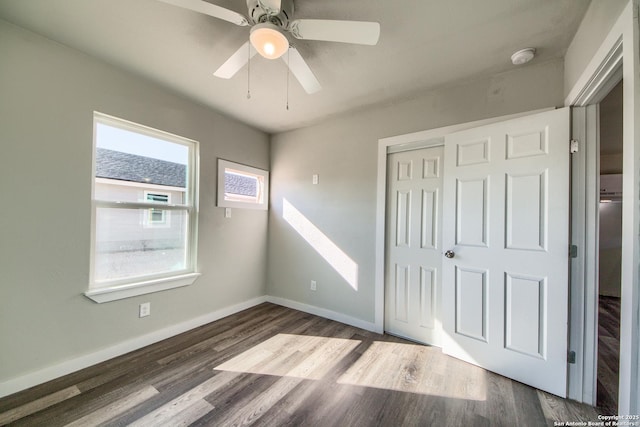 unfurnished bedroom with a closet, baseboards, ceiling fan, and wood finished floors
