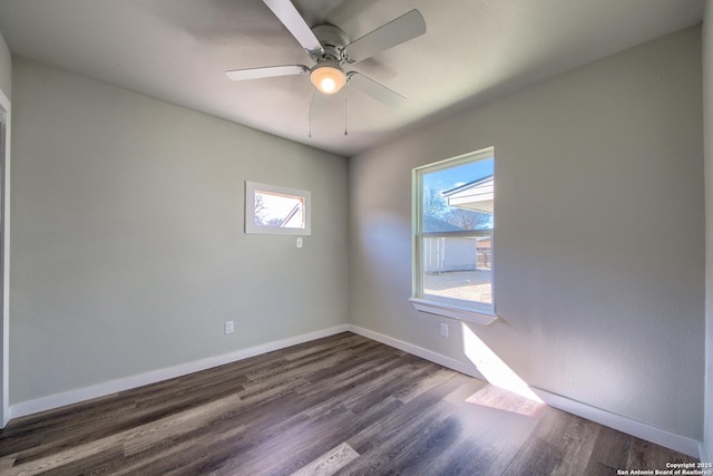 unfurnished room featuring baseboards, ceiling fan, and dark wood-type flooring