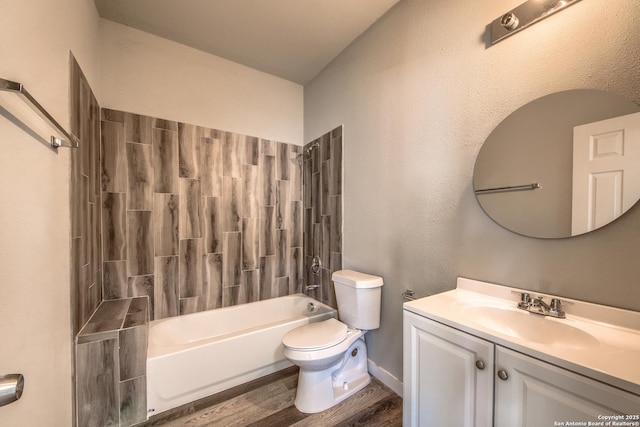 bathroom with vanity, washtub / shower combination, toilet, and wood finished floors