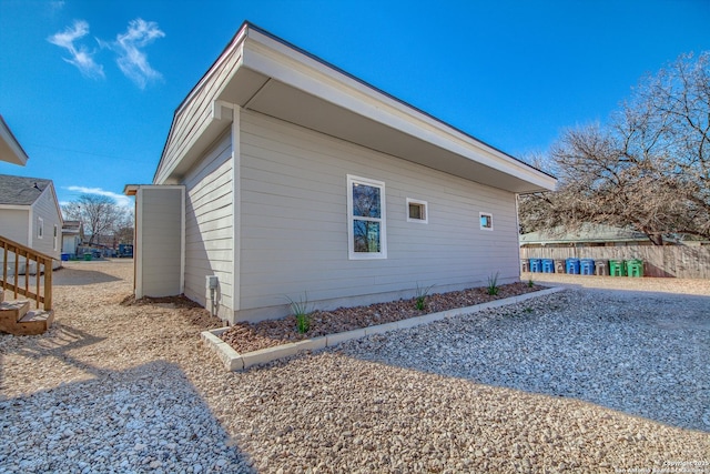 view of side of property featuring fence