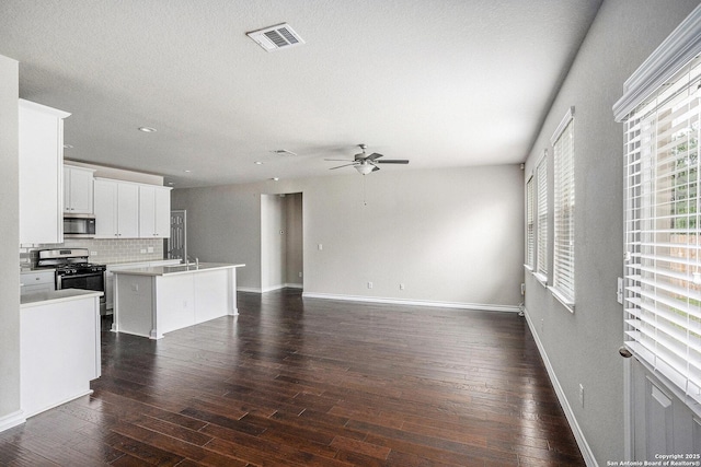 12448 Big Valley Crk, San Antonio, TX 78254 - unfurnished living room with visible vents, baseboards, dark wood-style floors, recessed lighting, and a ceiling fan